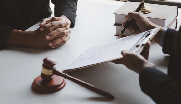 A gavel alongside scales of justice on a desk, representing the legal foundation and support provided in 24/7 bail bond services.