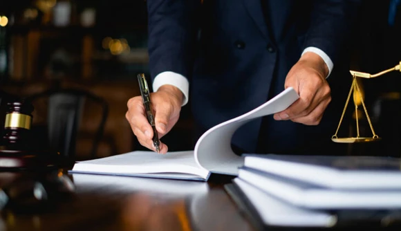 A gavel next to scales of justice on a desk, symbolizing the legal framework and essential support provided in 24/7 bail bond services.