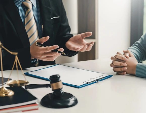 Close-up of a hand holding a gavel, symbolizing authority and decision-making in the legal process related to bail bonds.